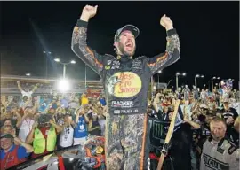  ?? Chris Graythen Getty Images ?? MARTIN TRUEX JR. basks in the spotlight after finishing first at HomesteadM­iami Speedway. “We gave it our all, and it was enough tonight,” he said.