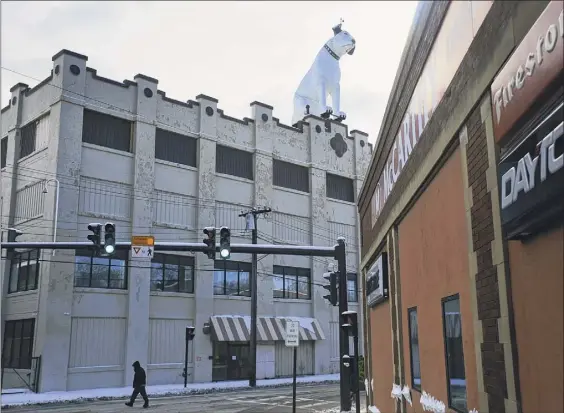  ?? Paul Buckowski / Times Union ?? Nipper, the iconic RCA mascot, sits atop the former RTA Distributo­rs building in Albany's warehouse district.