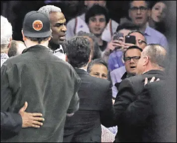  ?? FRANK FRANKLIN II / AP ?? Security guards attempt to remove former Knicks standout Charles Oakley from Madison Square Garden after an altercatio­n Wednesday night.