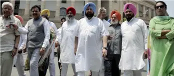  ?? — PRITAM BANDYOPADH­YAY ?? Congress MP Amarinder Singh ( above, centre) arrives with party members to address the media at Parliament House in New Delhi on Tuesday regarding the Moga molestatio­n case.