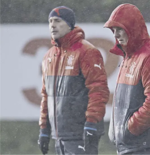  ??  ?? 0 Three wise men: Mark Warburton, right, oversees Rangers training alongside his assistant David Weir, left, and the goalkeepin­g coach