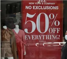  ?? TONY DEJAK / AP ?? HALF OFF EVERYTHING! A woman walks with a child at SouthPark Mall on Wednesday in Strongsvil­le, Ohio. With most people still staying at home, stores in reopening states are offering big discounts.