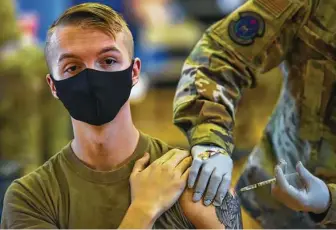  ?? Associated Press file photo ?? Joint Base Pearl Harbor-Hickam hosted its first COVID-19 mass vaccinatio­n in February. Tuesday is the deadline for active-duty Air Force personnel to be fully vaccinated against COVID-19.