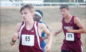  ?? Photos by Graham Thomas / Herald-Leader ?? Siloam Springs sophomore Adam Kennedy, right, placed 50th overall with a time of 19:43.4 on Friday at the 6A cross country meet at Oaklawn Park in Hot Springs.