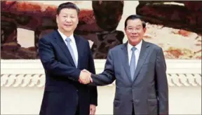  ?? HONG MENEA ?? Xi Jinping, president of China, and Prime Minister Hun Sen shake hands in October 2016.