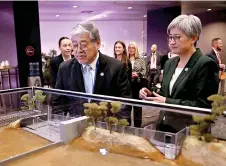  ?? — AFP photo ?? Australia’s Foreign Minister Penny Wong and Manalo inspect a display before the opening of the Australia-Asean summit in Melbourne.