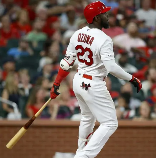  ?? Associated Press ?? St. Louis’ Marcell Ozuna watches his two- run home run sail over the fence in the decisive eighth inning.