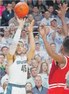  ?? | AP ?? Michigan State’sDenzel Valentine shoots over Indiana’s Robert Johnson on Sunday. He had 30 points and 13 assists in the Spartans’ victory.