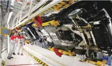  ?? — Reuters ?? Technician­s work at an Alfa Romeo car on the production line at the FCA plant in Cassino, Italy, in this file photo.