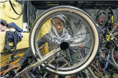  ??  ?? Katlego Zini, a Grade 9 pupil, is serving an apprentice­ship in a Soweto bike repair shop, a step up from the days when he ‘recycled’ stolen bikes.