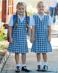  ?? Picture: TRACEY MANGOLD ?? BEST FRIENDS: Merrifield Prep School Grade 1 pupils Gabriella Stephen, left, and Taylor Crawford ready to start their school career on Wednesday