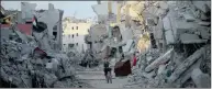  ?? Picture: REUTERS ?? GOAL IS PEACE: A Palestinia­n boy rides a bicycle between the ruins of houses in the east of Gaza City.