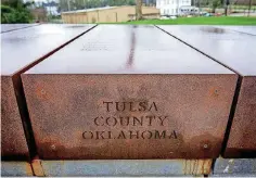  ?? [PHOTO BY ERIECH TAPIA, FOR THE OKLAHOMAN] ?? Outside of the memorial sits a field with unclaimed steel boxes with the names of individual­s lynched in counties across the United States. This Tulsa County box and the others are meant to be claimed by their respective counties and states.