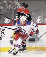  ?? Elsa / Getty Images ?? The Rangers’ Adam Fox checks the Devils’ Mikhail Maltsev in the first period at Prudential Center on Saturday in Newark, N.J.