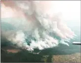  ?? BC Wildfire Service ?? An aerial photo provided by the BC Wildfire Service shows the Gottfrieds­en Mountain wildfire, burning in a remote area 24 kilometres west of West Kelowna.