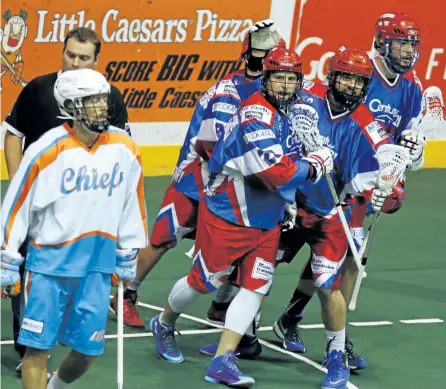  ?? CLIFFORD SKARSTEDT/EXAMINER ?? Peterborou­gh Century 21 Lakers' Cory Vitarelli, middle, celebrates his goal scored against Six Nations Chiefs' Dillon Ward during Major Series Lacrosse Final Game 5 action on Tuesday night at the Memorial Centre. Game 6 is Thursday night in Oshweken.