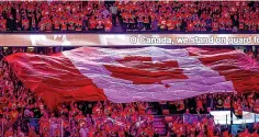  ?? Jeff McIntosh/The Canadian Press via The Associated Press ?? ■ Calgary Flames fans sing the Canadian national anthem before Game 1 of the team’s first-round playoff series against the Dallas Stars on May 3 in Calgary, Alberta.