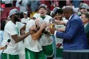  ?? LYNNE SLADKY/ASSOCIATED PRESS ?? Boston’s Jayson Tatum, center, is mobbed by teammates while receiving the NBA Eastern Conference MVP trophy Sunday night.