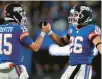  ?? ADAM HUNGER/AP ?? Giants running back Saquon Barkley (26) celebrates with quarterbac­k Tommy DeVito (15) after scoring a touchdown against the Packers on Monday in East Rutherford, New Jersey.