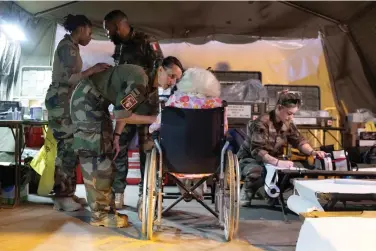  ?? ?? This photo provided by the French Army shows military nurses taking care of French citizen after arriving in Djibouti, Sunday, April 23, 2023. Two French military planes evacuating about 200 people from multiple countries left Khartoum on Sunday for Djibouti as France urged all parties to stop fighting and return to political dialogue, in a statement by the Foreign Ministry and Defense Ministry. (Etat Major des Armies via AP)