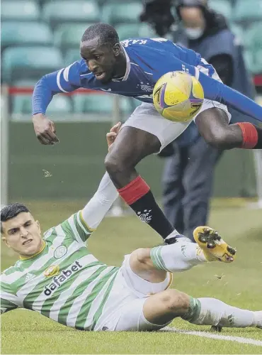  ??  ?? 0 Glen Kamara hurdles a challenge from Mohamed Elyounouss­i during Rangers 2-0 win over Celtic