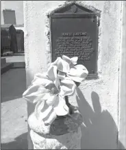  ??  ?? Offering: This photo shows an offering and plaque marking the tomb for Marie Laveau at St. Louis Cemetery No. 1 in New Orleans. The marker calls her the "notorious voodoo queen ... the most widely known of many practition­ers of the cult."