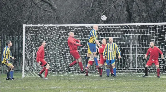  ??  ?? Houghton Cricket Club Over-40s (red kit) contest an aerial battle against Sunderland The Philadelph­ia at Leyburn Grove on Saturday