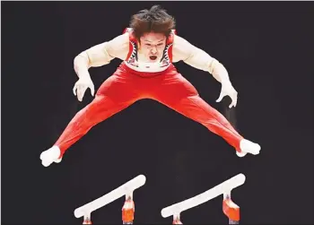  ??  ?? Japanese gymnast Kohei Uchimura competes on the parallel bars during the Men’s Team event final on the sixth day of
the 2015 World Gymnastics Championsh­ip in Glasgow, Scotland on Oct 28. (AFP)