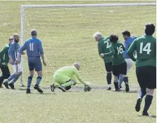 ??  ?? Goalmouth action as Rolls-Royce over-40s face the Doxy Lad