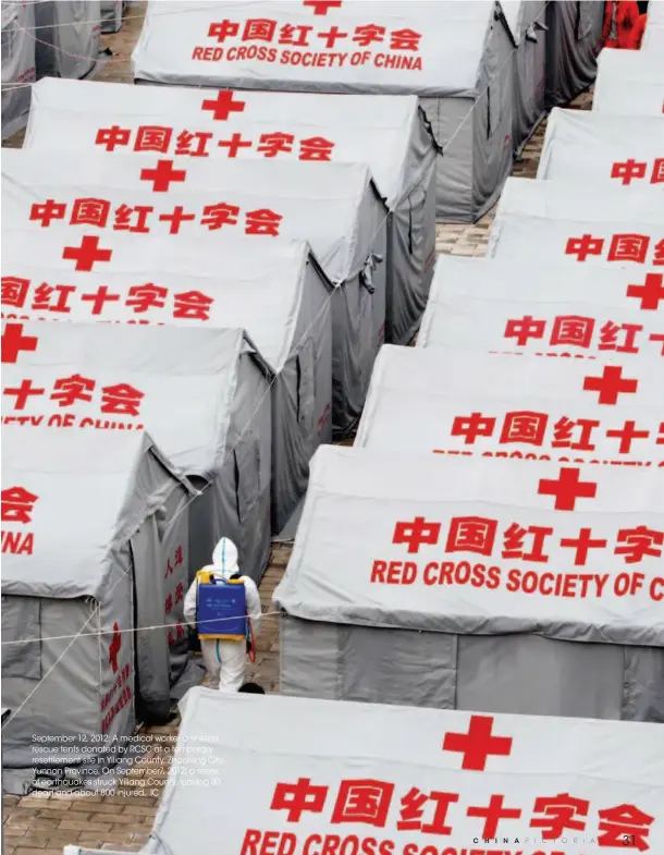  ??  ?? September 12, 2012: A medical worker disinfects rescue tents donated by RCSC at a temporary resettleme­nt site in Yiliang County, Zhaotong City, Yunnan Province. On September7, 2012, a series of earthquake­s struck Yiliang County, leaving 80 dead and...