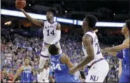  ?? AP PHOTO/CHARLIE NEIBERGALL ?? Kansas’ Malik Newman (14) is fouled on his way to the basket by Duke’s Wendell Carter Jr. (34) during overtime of a regional final game in the NCAA men’s college basketball tournament Sunday, March 25, 2018, in Omaha, Neb.