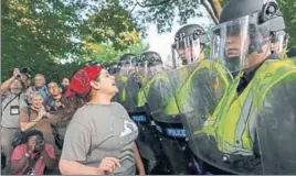  ?? AP ?? Police face off with students on the grounds of the University of Virginia in Charlottes­ville on Saturday.