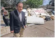  ?? Melissa Phillip / Houston Chronicle ?? John Sharp tours a flooded neighborho­od near Westbury High School last week in Houston. He routinely gives his cellphone number to officials.