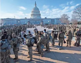  ?? JASPER COLT/USA TODAY ?? National Guard troops line up Wednesday as security around the U.S. Capitol is heightened as the House of Representa­tives reconvened to debate impeaching President Donald Trump and ahead of Inaugurati­on Day.