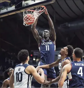 ?? Jenna Watson / Associated Press ?? UConn forward Akok Akok dunks against Butler during the first half during a game in January.