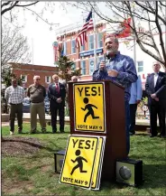  ?? NWA Democrat-Gazette/FLIP PUTTHOFF ?? Travis Riggs, Bentonvill­e School Board president, voices his support for a millage increase Tuesday during a rally in downtown Bentonvill­e. The millage election is May 9.