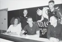  ?? CRAIG CAMPBELL/METROLAND ?? Dundas Valley Secondary School student and track star Alec Purnell shares a laugh with, from left, Mom Andrea, Dundas Valley track coach Michael Smith, University of Guelph track coach Dave Scott-Thomas and Dad Aidan, after signing with the Guelph Gryphons track team last May.