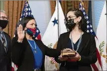  ?? AP PHOTO/ALEX
BRANDON ?? Interior Secretary Deb Haaland, center, with daughter Somah Haaland, right, holds her hand up during a ceremonial swearing in with Vice President Kamala Harris, in the Vice President’s ceremonial office in the Eisenhower Executive Office Building on the White House campus on March 18 in Washington.