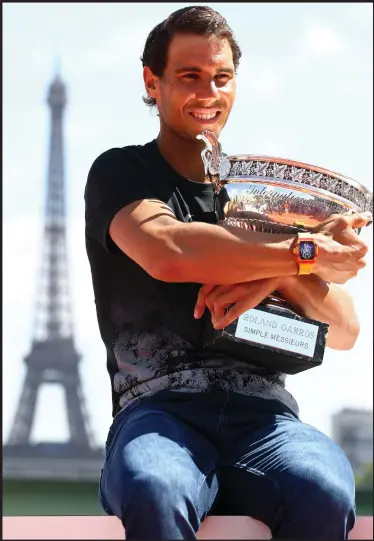  ??  ?? Rafael Nadal celebrates his record-breaking 10th French Open title in Paris