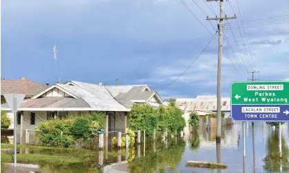  ?? Photograph: Lucy Cambourn/AAP ?? An inundated street in Forbes on Sunday. The north-west New South Wales towns of Lightning Ridge, Collareneb­ri and Walgett have been cut off by floods.