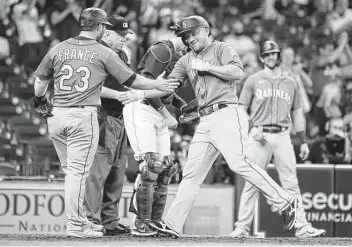  ?? Photos by Karen Warren / Staff photograph­er ?? Kyle Seager, right, celebrates his three-run homer, which capped a Mariners comeback and allowed them to salvage the final game of the series after two consecutiv­e blowout losses at the hands of the Astros.