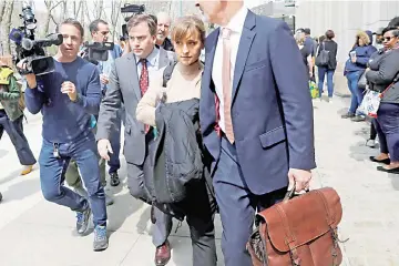  ??  ?? Actress Allison Mack departs the Brooklyn Federal Courthouse after facing charges regarding sex traffickin­g and racketeeri­ng related to the Nxivm cult case in New York, US, Monday. — Reuters photo