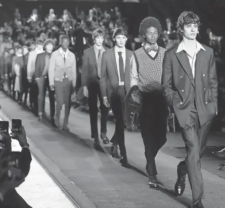  ??  ?? Models showcase suits during a Brooks Brothers fashion show in Italy in 2018. BROOKS BROTHERS