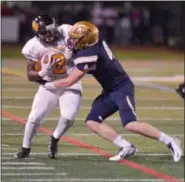  ?? GENE WALSH — DIGITAL FIRST MEDIA ?? Archbishop Wood’s Leroy Pendleton is tackled near the sideline by La Salle’s Dillon Trainer Friday night.