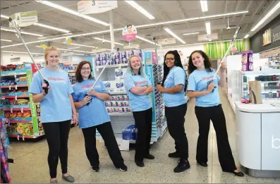  ?? Photo by Ernest A. Brown ?? Armed with their garbage pickers, Walgreens workers, from left, Erica Matchett and Lisa Darling, both customer service associates, shift leader Brittany Derr, community management intern Sara Gilkenson, who organized the cleanup on Sunday, and store...