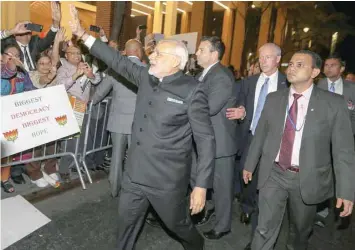  ?? — Reuters ?? Narendra Modi waves to well wishers after arriving at his hotel in Manhattan.