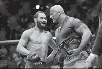  ?? FRANK FRANKLIN II/AP PHOTO ?? Jorge Masvidal, left, talks to Dwayne “The Rock” Johnson after a welterweig­ht mixed martial arts bout against Nate Diaz at UFC 244 early Sunday in New York. Masvidal won in the fourth round.