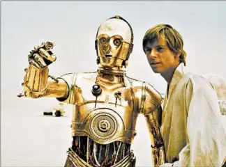  ?? LUCASFILM LTD. ?? C-3PO (Anthony Daniels, left) and Luke Skywalker(Mark Hamill) are shown during the making of “Star Wars: A New Hope.” Daniels is the only actor to have voiced the character in film, TV or otherwise.