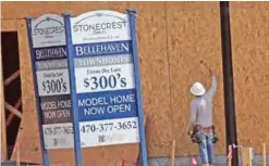  ?? — AP ?? WOODSTOCK: In this May 16, 2017 photo, a constructi­on worker continues work on new town homes under constructi­on in Woodstock, Ga.