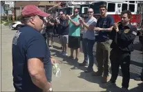  ?? PETE BANNAN - MEDIANEWS GROUP ?? Area firefighte­rs applaud the Manoa captain as he arrives home.